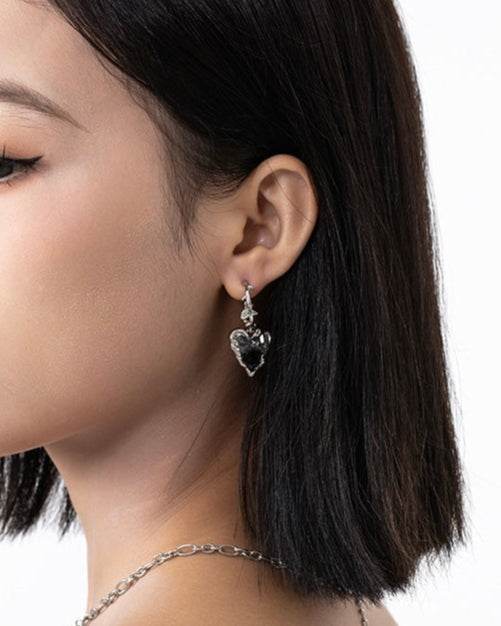 Black Crystal Heart Earrings worn by model in relaxed lifestyle setting
