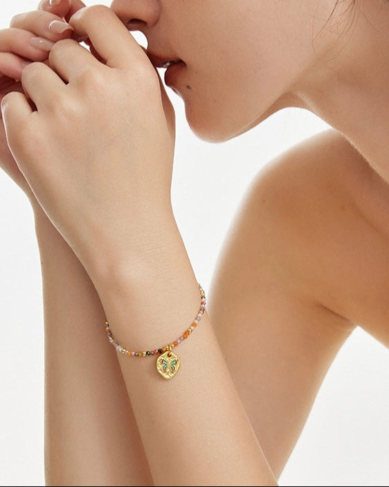 Butterfly Bloom Beaded Bracelet styled on model with layered casual accessories