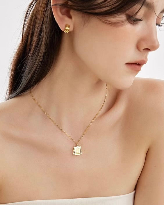 Framed Love Necklace worn with casual outfit for layered jewelry look