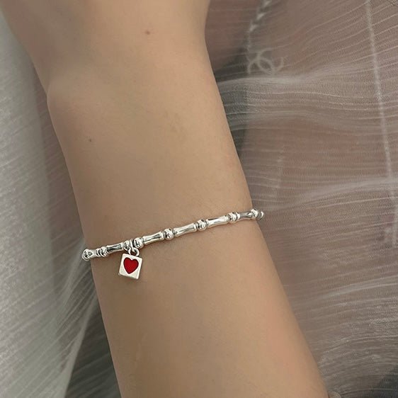 Heart Lock Bracelet worn by model in relaxed lifestyle setting with casual styling