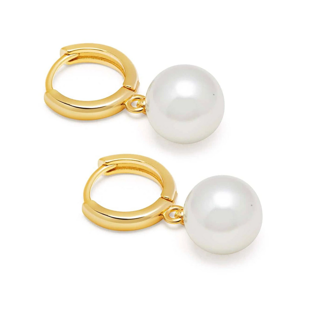 Close-up of gold pearl drop earrings
