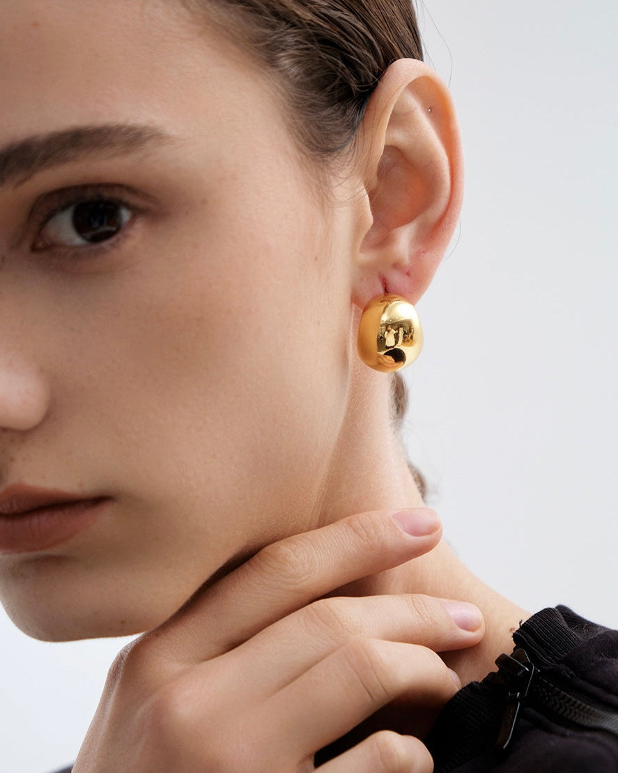 Sculpted Hoop Earrings close-up worn by model showing organic gold texture