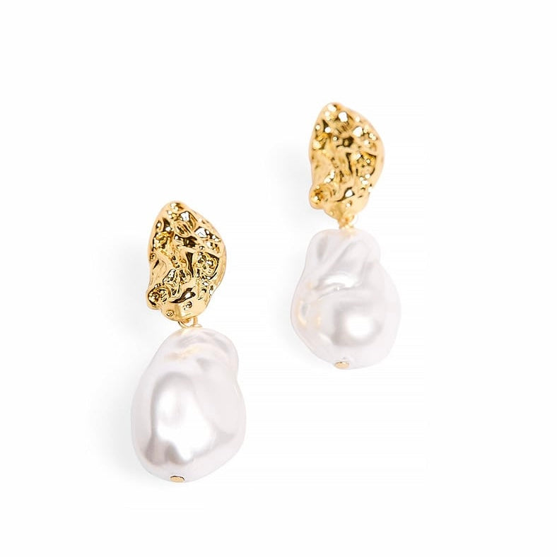 Close-up detail of Sculpted Pearl Earrings showing pearl and gold finish on white background