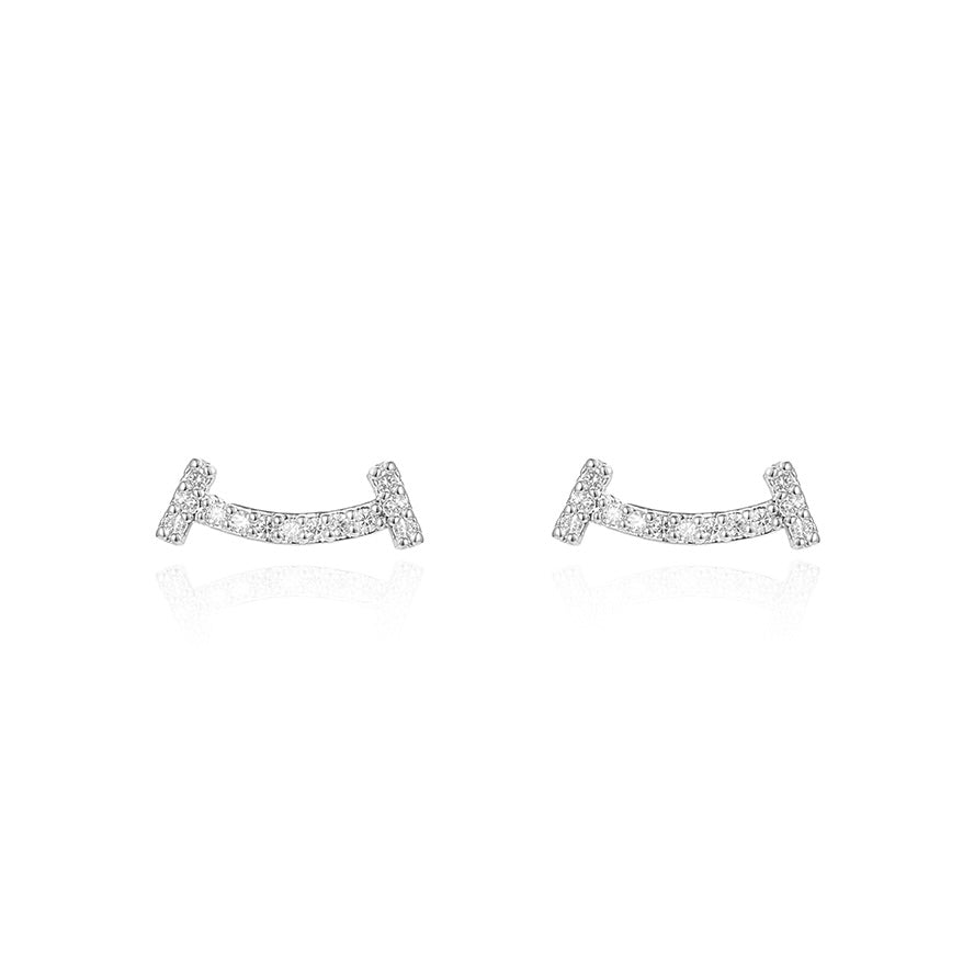 Pair of silver earrings with small diamonds on a white background