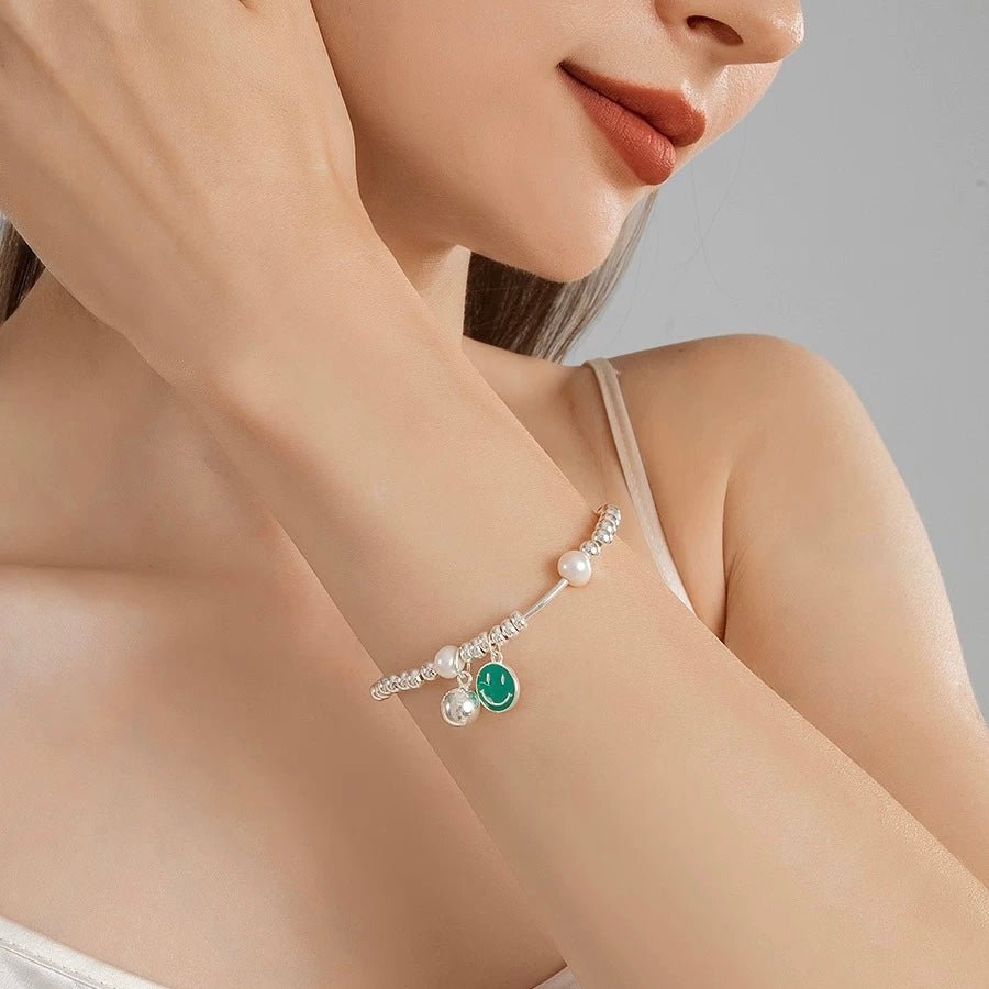 Smiley Pearl Bracelet styled on model with layered pearl accessories