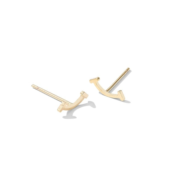 Gold U-shaped earrings on a white background