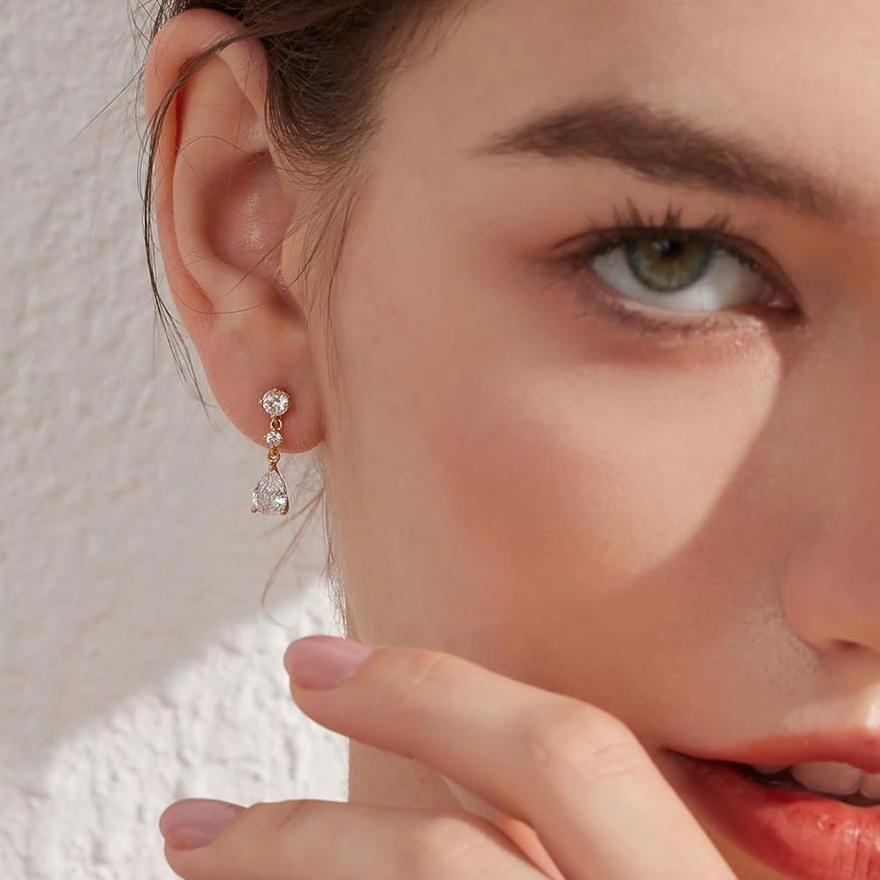 Close-up of a woman wearing earrings with a neutral background