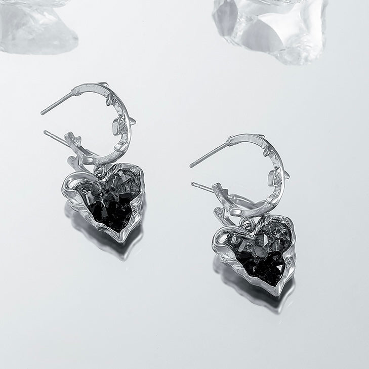 Close-up detail of Black Crystal Heart Earrings highlighting gold setting and crystal heart design
