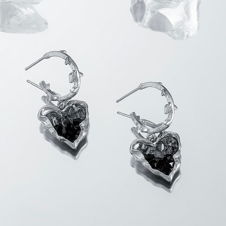 Close-up detail of Black Crystal Heart Earrings highlighting gold setting and crystal heart design
