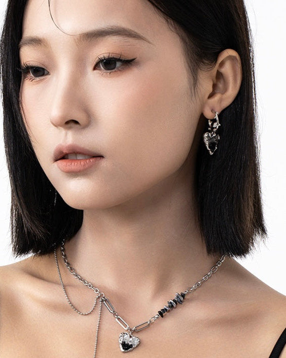 Black Crystal Heart Earrings styled on model with casual outfit
