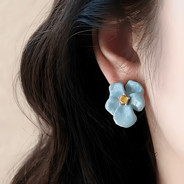 Blue Blossom Stud Earrings worn by model showcasing blue enamel floral detail
