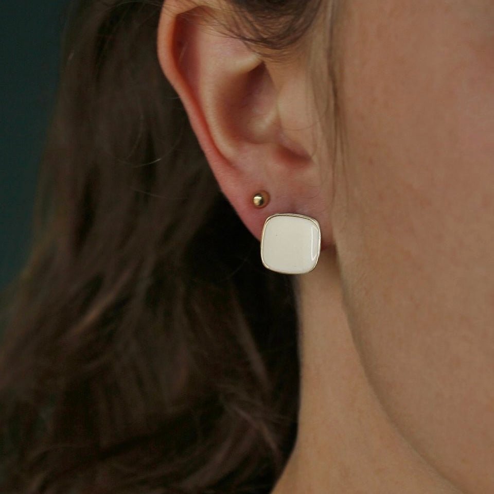 Bordeaux Enamel Earrings worn by model showcasing red enamel and gold-tone design