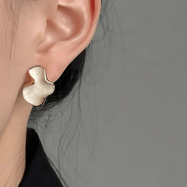 Cloudform Earrings worn by model showing sculpted gold shape and fit