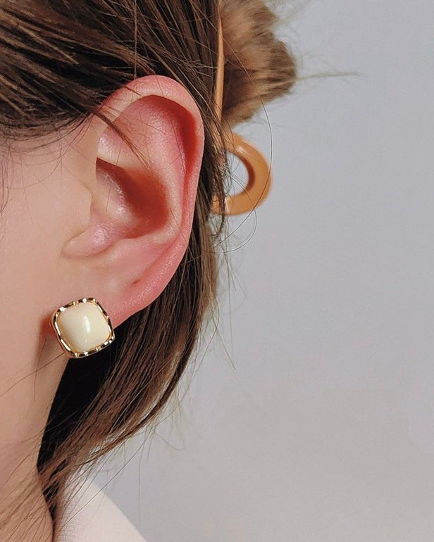 Creme Enamel Stud Earrings worn by model showing cream enamel and gold detail
