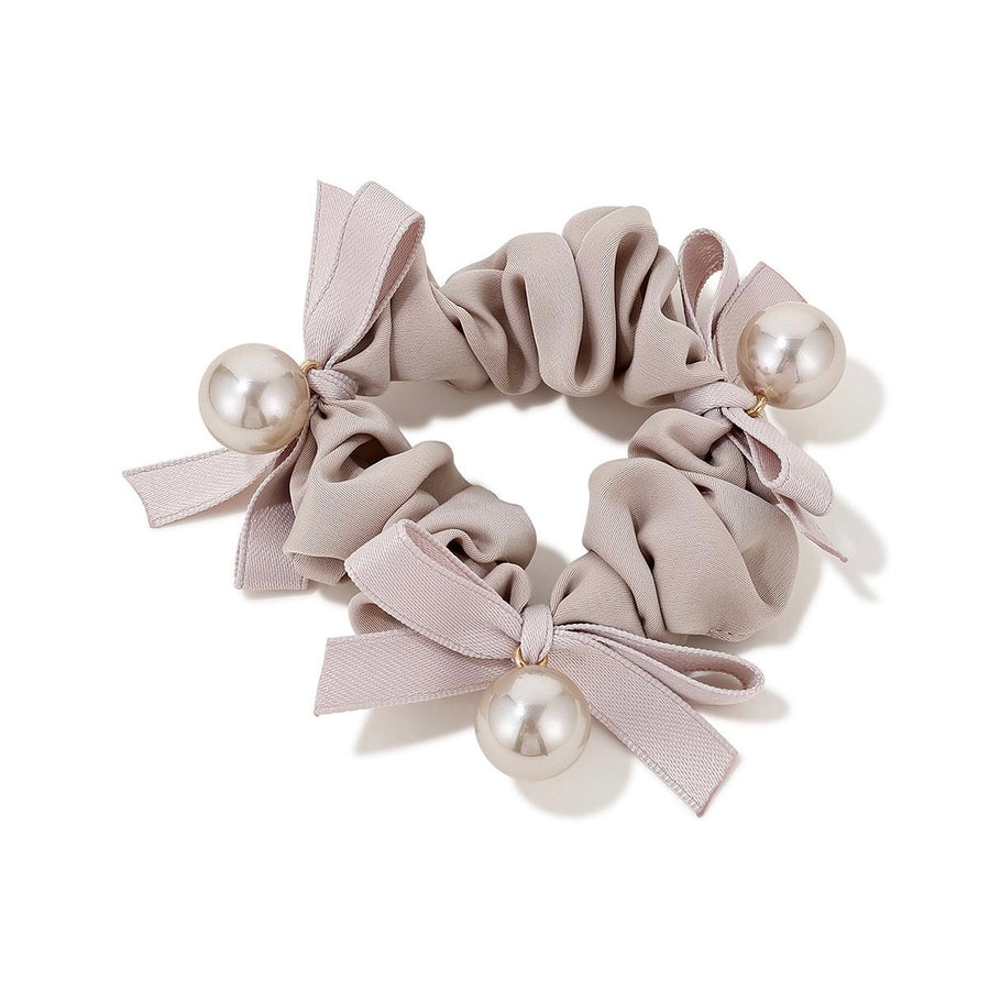 Elegant Pearl Bow Scrunchie in cream color with pearl accents on white background