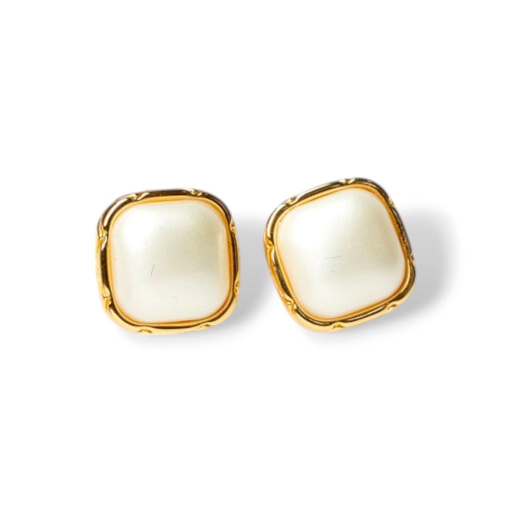 Close-up of creme enamel stud earrings with ivory center and gold-tone trim, perfect vintage-inspired enamel earrings for daily wear.