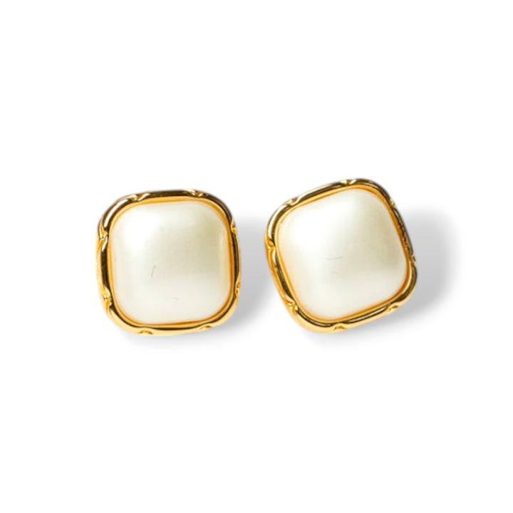 Close-up of creme enamel stud earrings with ivory center and gold-tone trim, perfect vintage-inspired enamel earrings for daily wear.