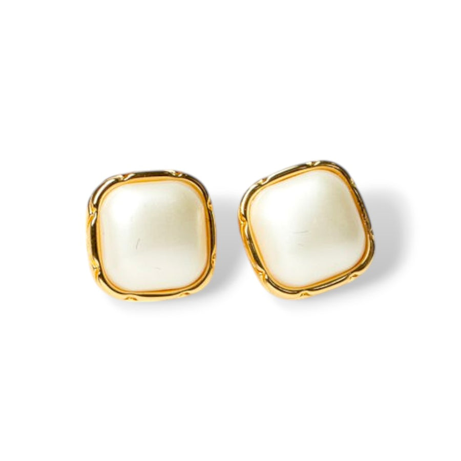 Close-up of creme enamel stud earrings with ivory center and gold-tone trim, perfect vintage-inspired enamel earrings for daily wear.