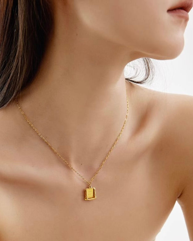 Framed Love Necklace close-up showing engraved pendant worn by model