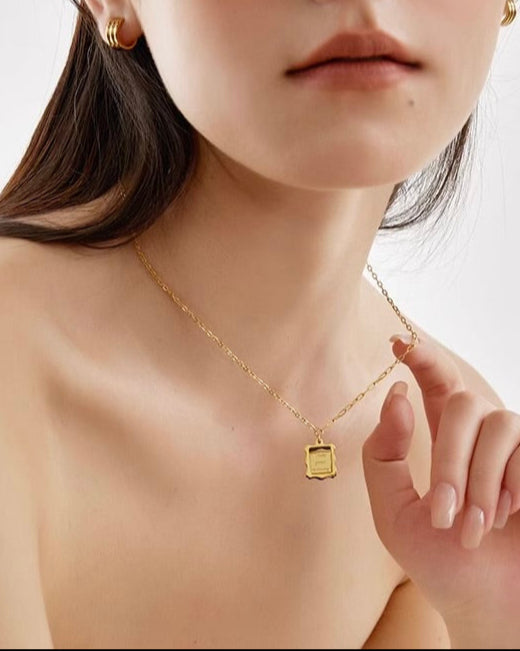Framed Love Necklace layered on model highlighting neckline styling