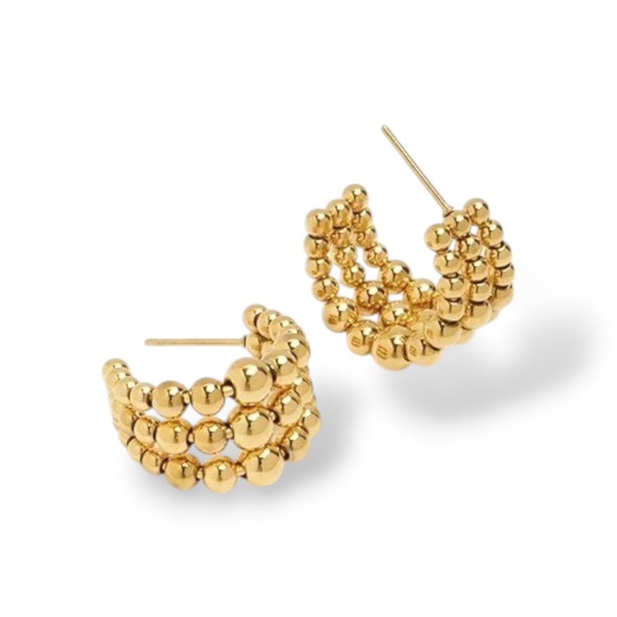Gold hoop earrings with bead detailing on a white background