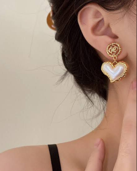 Heart Drop Earrings worn by model showcasing gold heart charms and drop design
