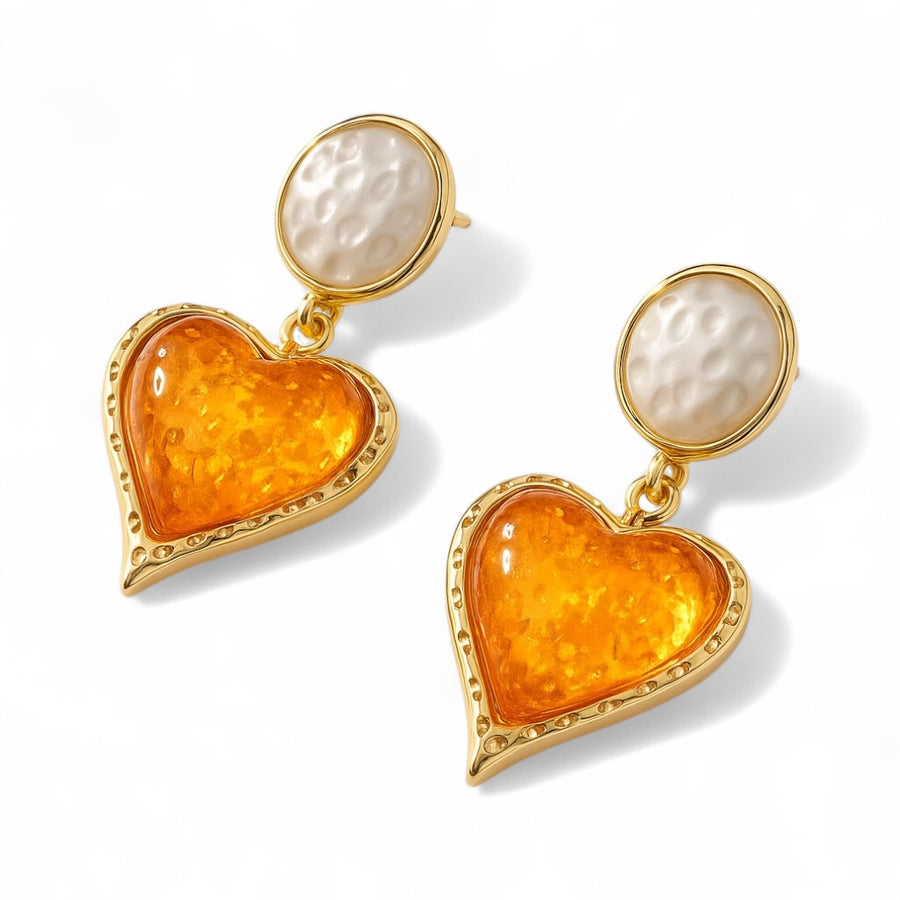 Lustrous Heart Earrings with polished gold-tone heart design on white background
