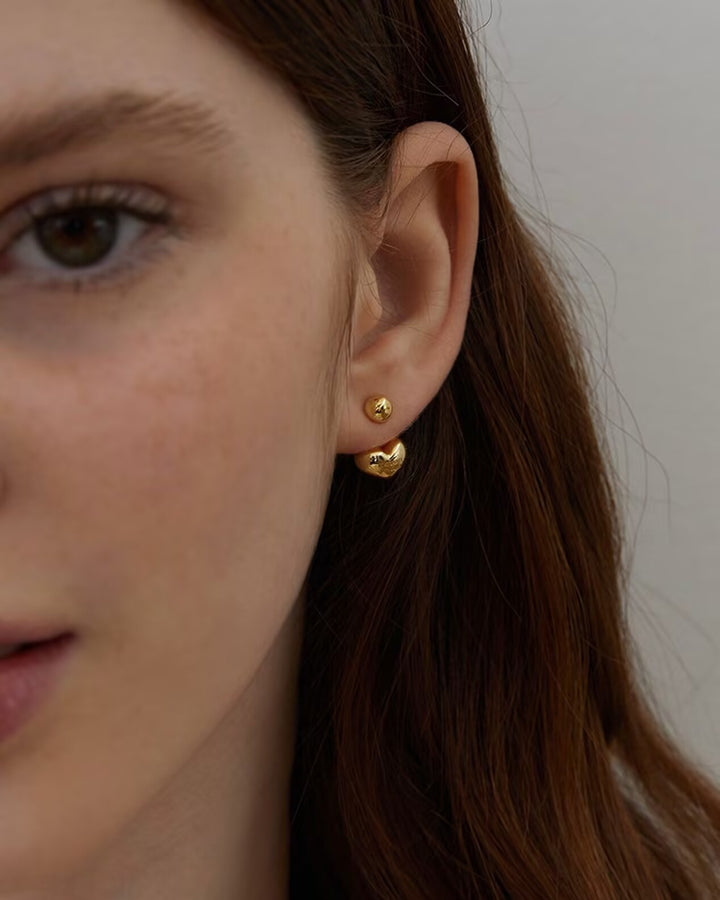 Mini Heart Earrings close-up worn by model showing gold heart detail
