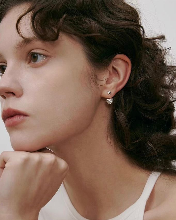 Mini Heart Earrings worn by model in relaxed lifestyle setting
