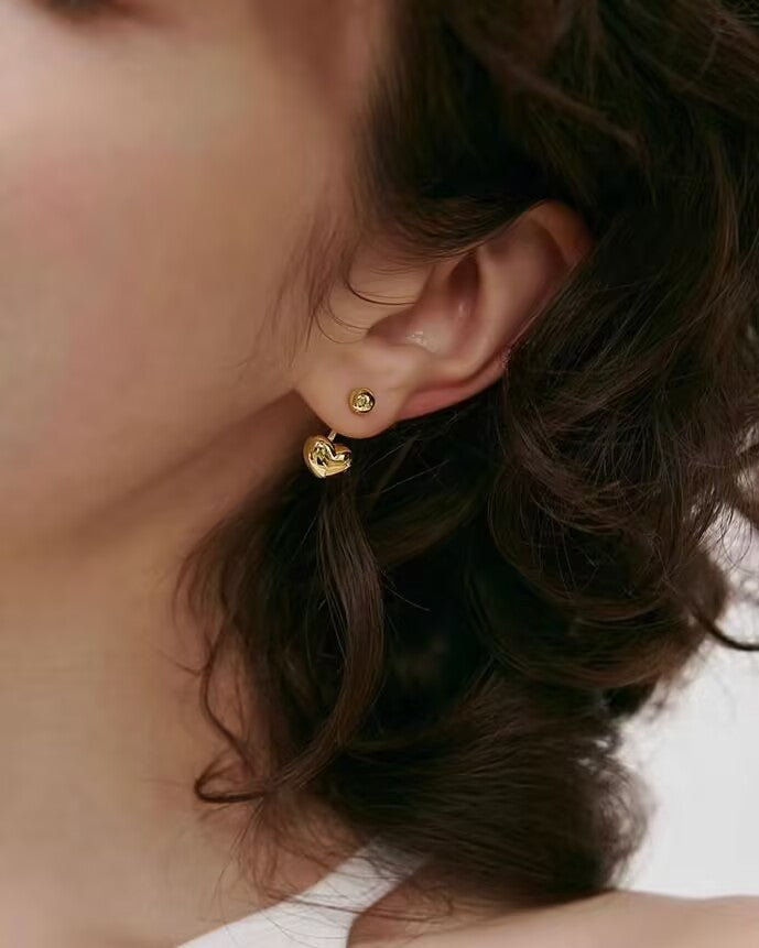 Mini Heart Earrings styled on model with casual outfit

