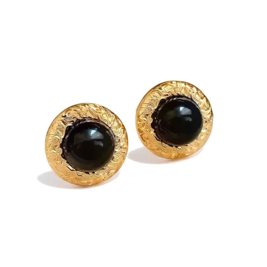 Noir Crest Earrings with black enamel and gold-tone crest detail on white background