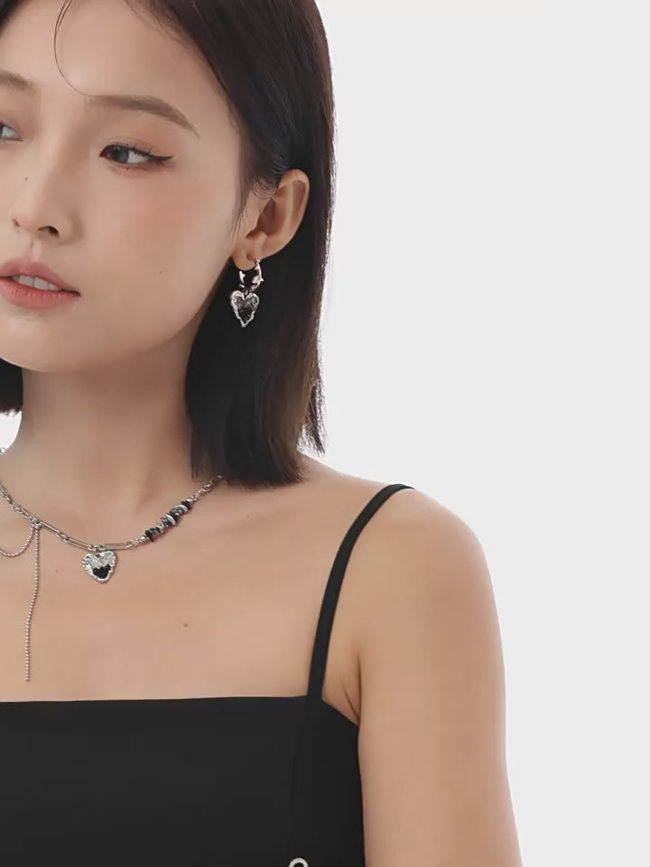 black-crystal-heart-earrings-closeup-on-model
