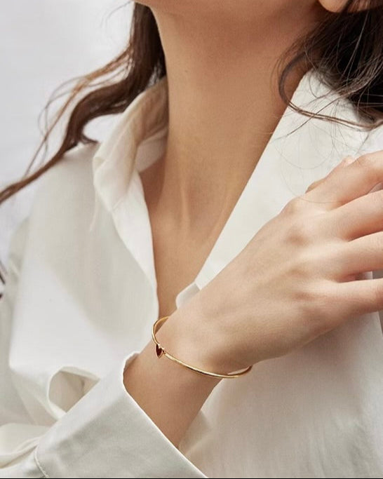 Red Heart Bangle close-up worn on model showing heart charm detail