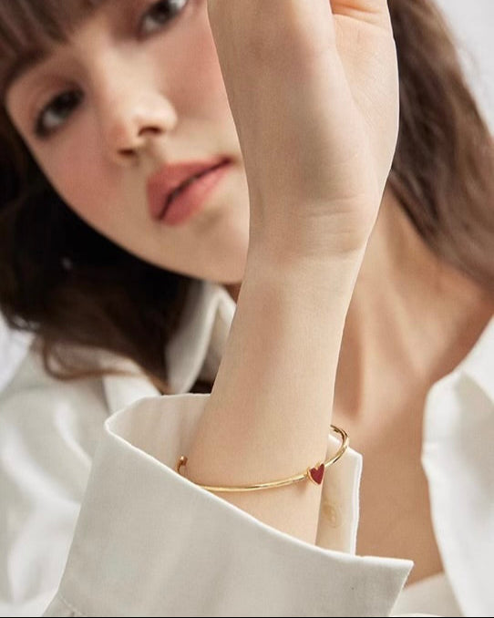 Red Heart Bangle worn by model in relaxed lifestyle setting