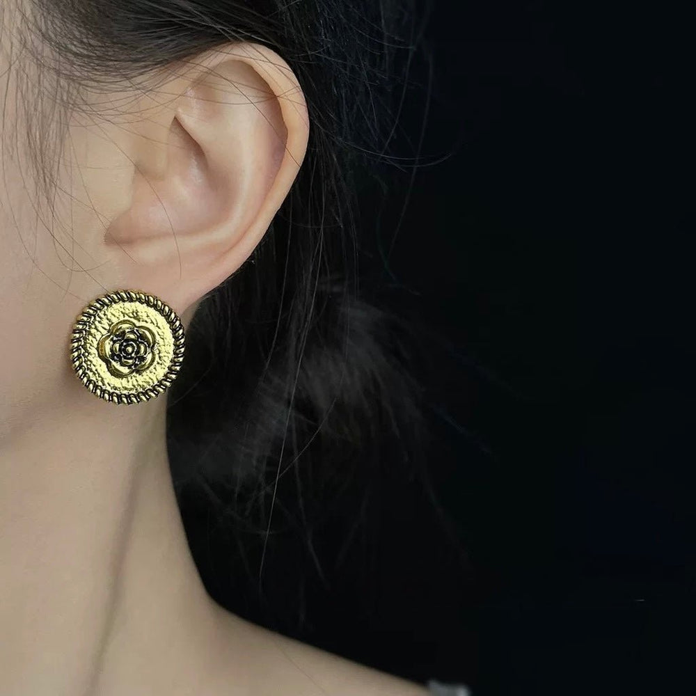 Rose Crest Earrings worn by model showing gold crest detail and fit
