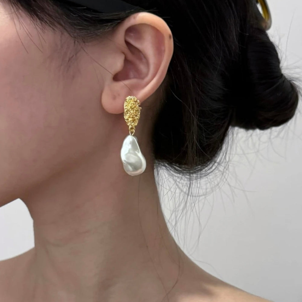 Sculpted Pearl Earrings worn by model showcasing organic gold shape and pearl detail