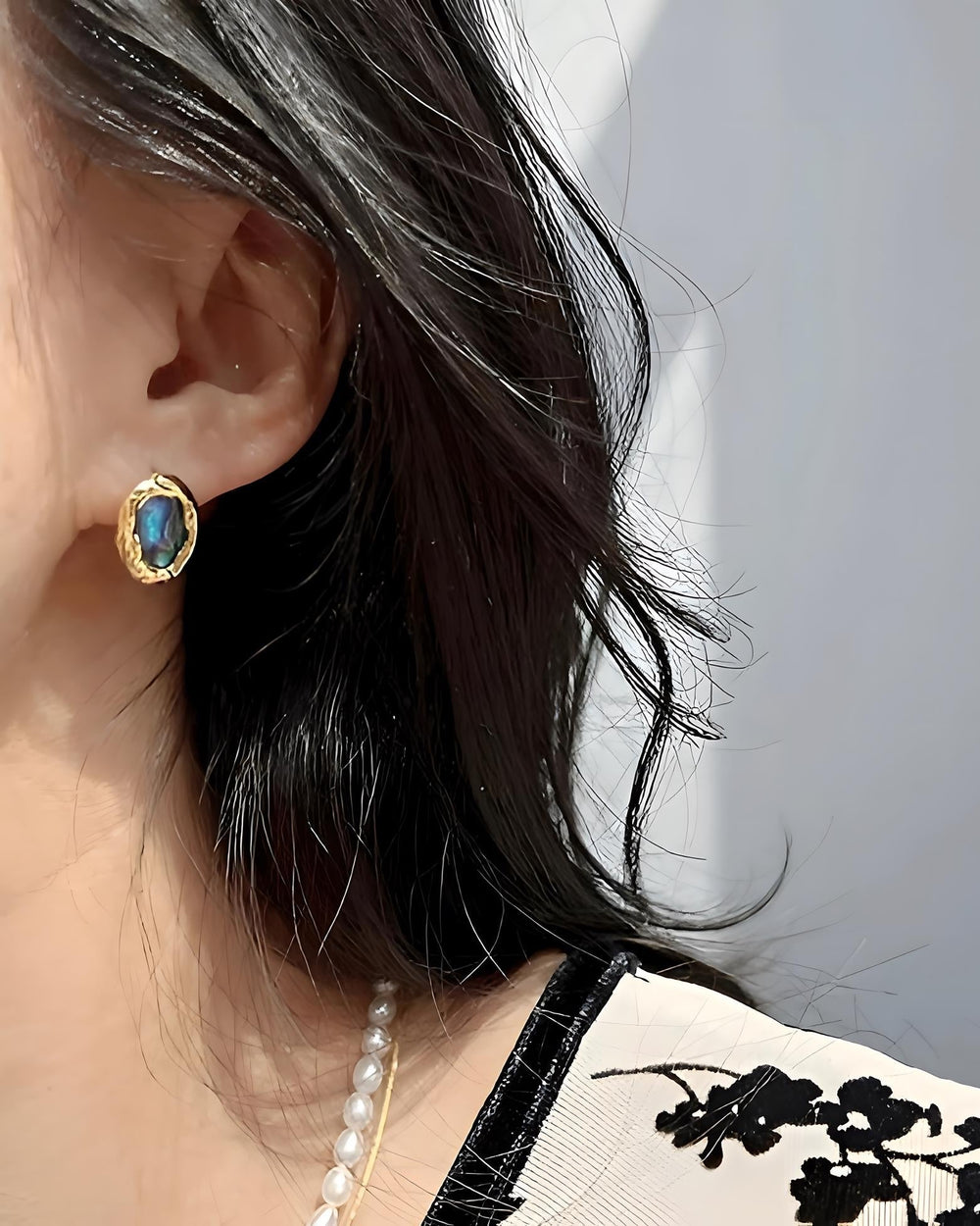 Shell Earrings worn by model showcasing gold and shell design