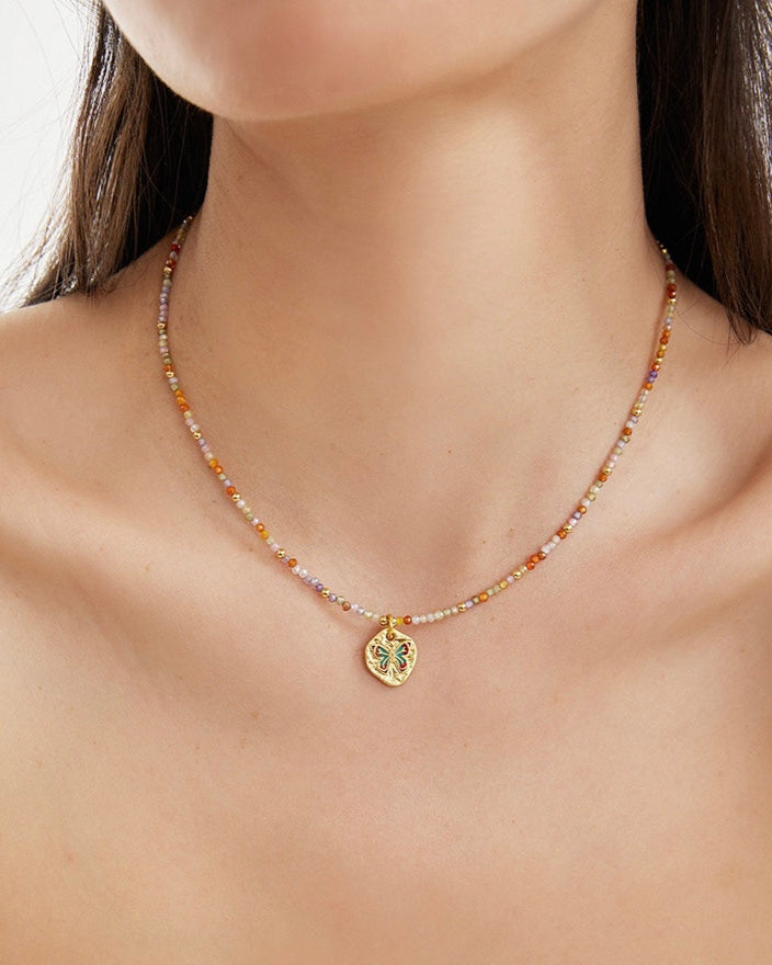 Starlit Charm Necklace layered on model with star details in close view