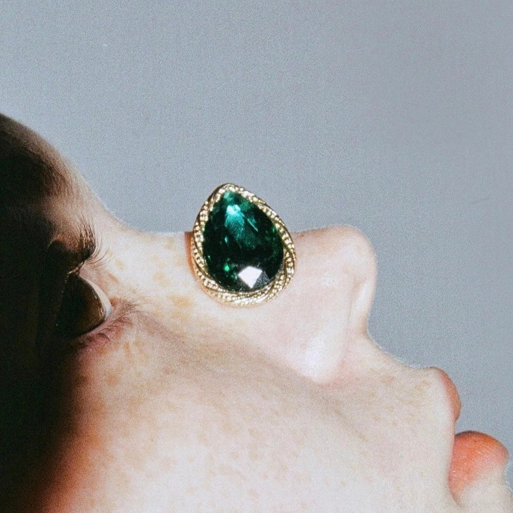 Teardrop Earrings close-up worn by model showing gold teardrop shape and fit