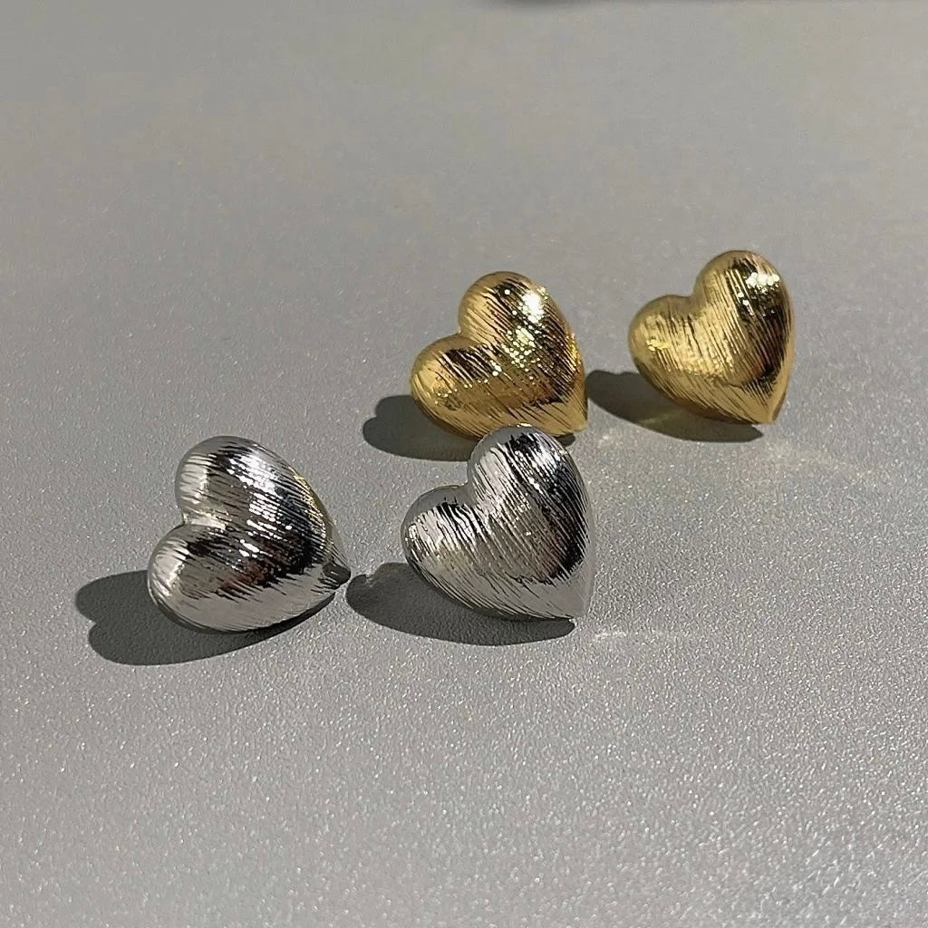 Textured Heart Earrings laid flat to show heart design and textured detail