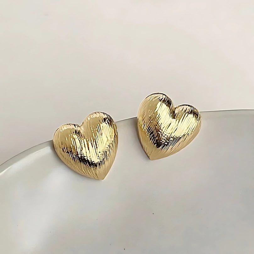 Textured Heart Earrings shown from side angle highlighting gold heart shape