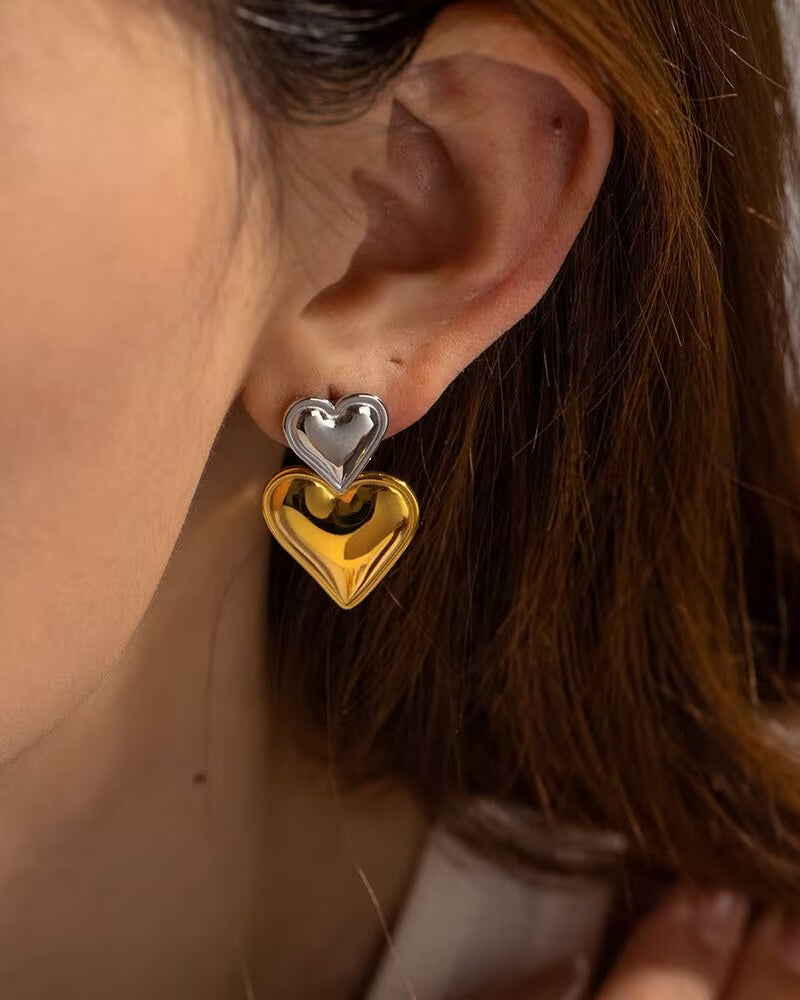 Two-Tone Heart Earrings close-up worn by model showing gold and silver heart detail
