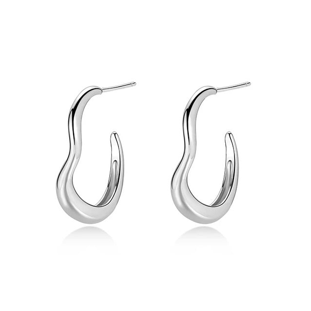 Close-up detail of Wave Hoop Earrings showing gold-tone wave texture on white background
