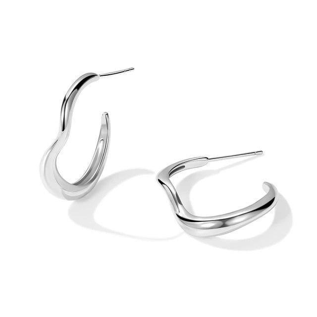 Wave Hoop Earrings with gold-tone sculpted wave design on white background
